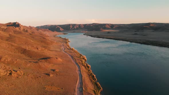 Drone Shot of River and Mountains at Sunset in Kazakhstan