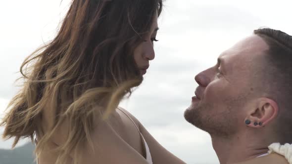 Happy Man Holds Pretty Asian Girlfriend Sailing Yacht on Sea