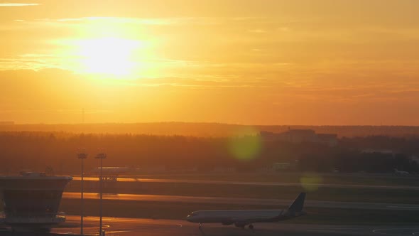  - Airport View with Moving Plane at Golden Sunset
