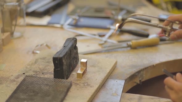 Close-up of female goldsmith working on jewlery