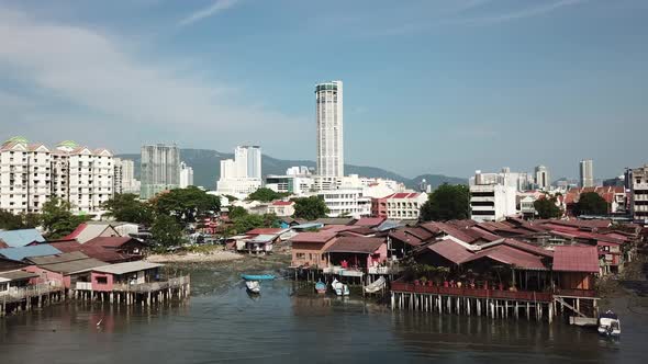 Aerial view fly towards wooden bridge at seashore at Georgetown Penang.