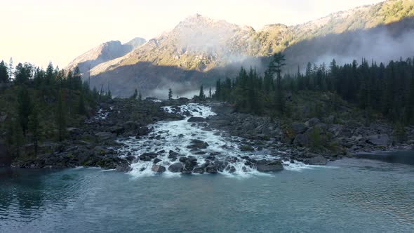 Aerial Flying Creek and Waterfall in Altai Mountain