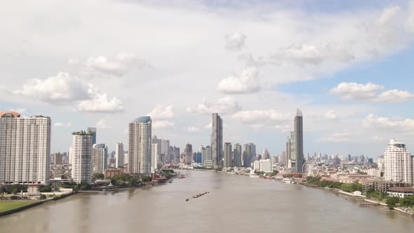 Aerial Panorama view of Bangkok Skyline through Chao Phraya river Riverbank, Thailand