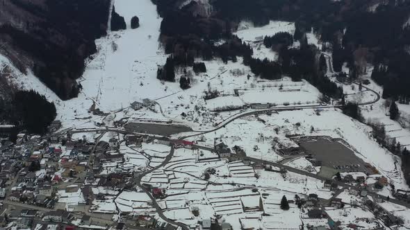 base of the mountain ski resort in nozawa onsen nagano japan with little snow in winter, aerial