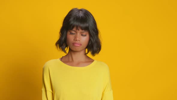 Unhappy Serious Dark Skinned Woman Shakes Head Says No Against Yellow Background