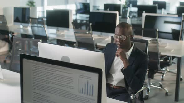 Serious African American Employee Thinking Over Business Email Working on Computer in Office Focused