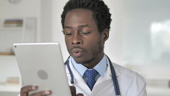 African Doctor Using Tablet in Clinic
