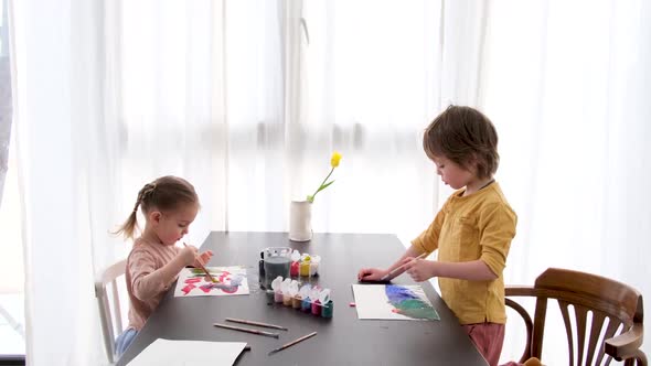 Children Drawing with Brush in Album