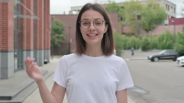 Young Woman Talking on Online Video Call while Walking on Street