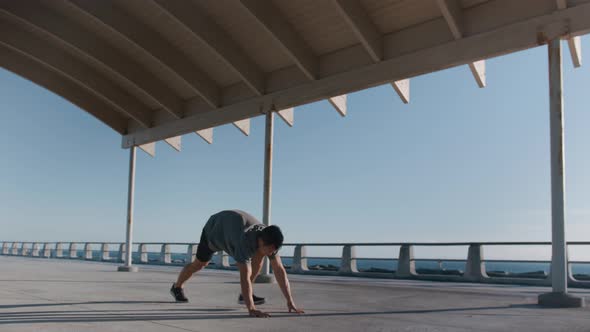 Young Fit Man Doing Stretching Exercise Outside