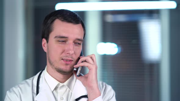 Doctor Speaks On Smartphone In Hospital
