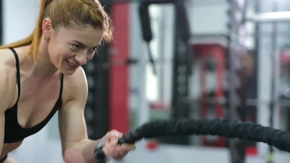 Sportswoman Working Out in Functional Training Gym Doing Exercise with Battle Ropes