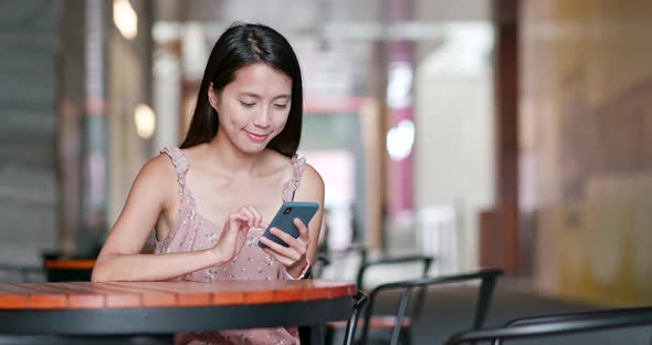 Woman use of smart phone in outdoor cafe