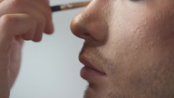 Applying Eyeshadow on Bottom Lid of Male Model