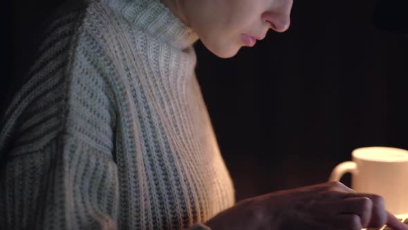 Portrait of a female working at the computer at night