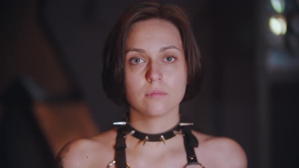 BDSM Concept - Young Woman in Black Spiked Collar