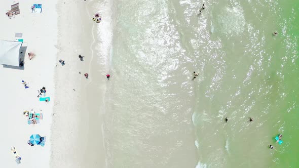 Aerial Top to Down Drone View of Ocean Waves Crashing on Beach