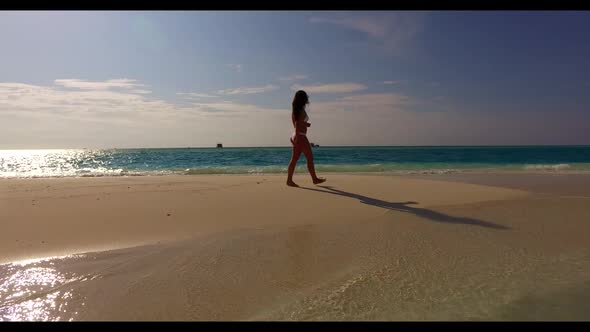 Female model sunbathes on luxury seashore beach journey by blue lagoon and white sand background of 
