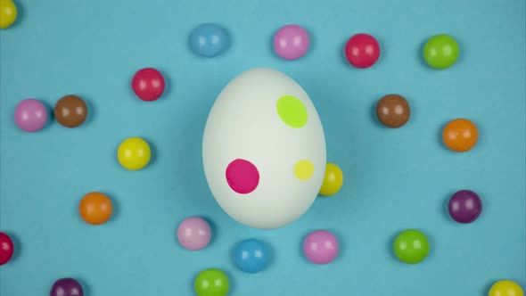 Round Colored Candies Move Near Egg and Paint it in the Easter Egg. Stop Motion Animation