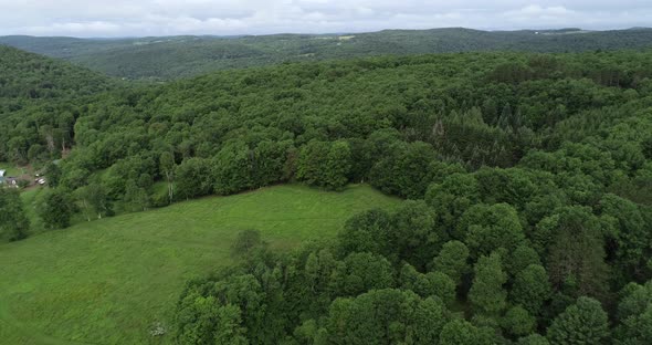 A drone floats backward revealing a beautiful Catskill Mountain landscape in upstate New York near W