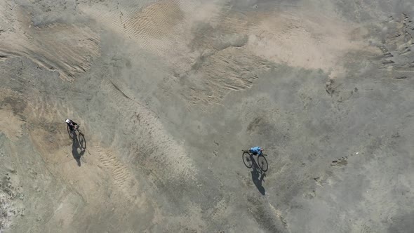 Aerial View of Cycling Travelers Riding Through the Desert.