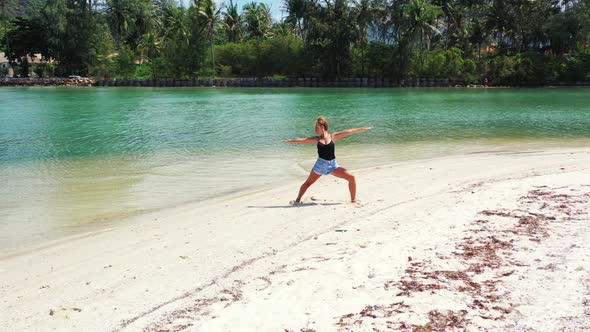 Girls enjoying life on tranquil lagoon beach vacation by aqua blue ocean with white sandy background