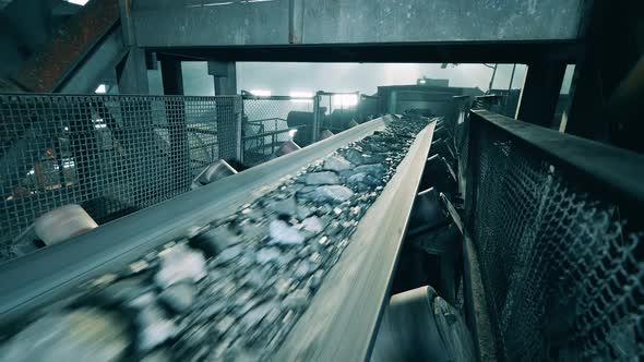 Crushed Minerals are Getting Transported By a Conveyor Complex
