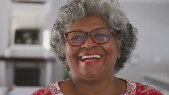 A senior african american woman smiling at the camera. social distancing in quarantine.