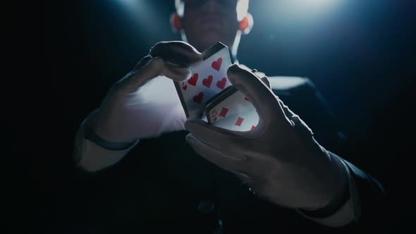 Close-up of a Suited Magician's Hands Performing Sleight of Hand Card Tricks, Slow Motion
