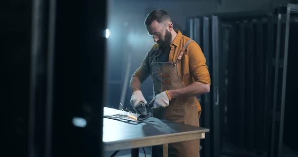 Man Working with Metal at the Workshop