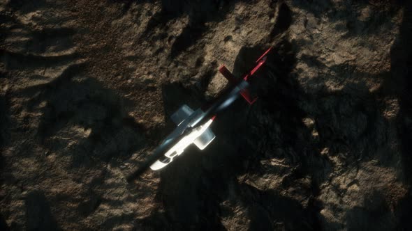 Slow Motion Helicopter Above Rocky Desert alt