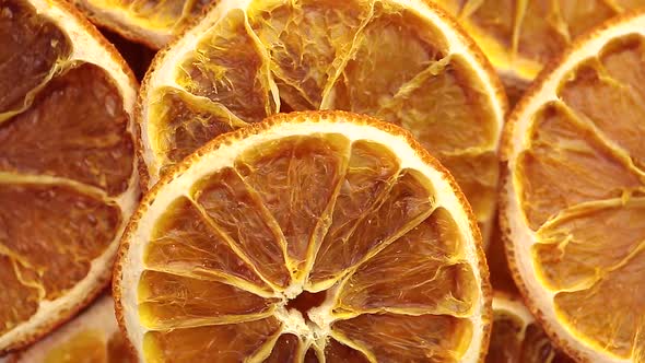 Dried oranges sliced in slices top view with circular rotation