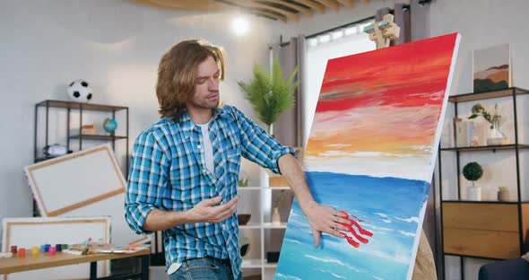 Man-Painter Drawing Picture on Canvas with Hands in Paint, Working in Home