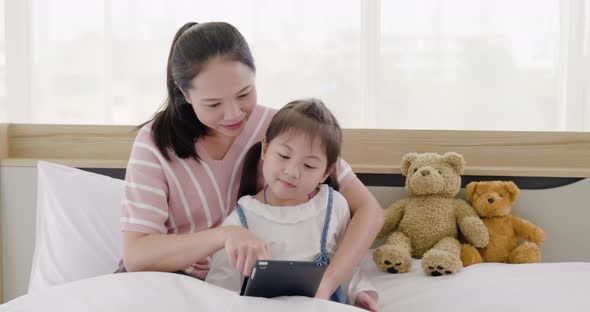 Mother and daughter watching tablet (1)