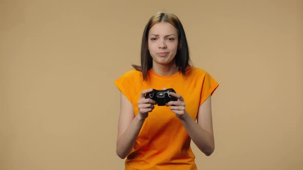 Portrait of Fashion Model Playing Video Game Using Wireless Controller and Rejoicing in Victory
