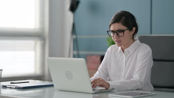 Indian Businesswoman Reacting to Loss While using Laptop