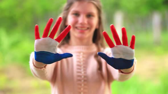 Teenager Girl Waving Greeting with Hands Painted in Mongolia Flag Color