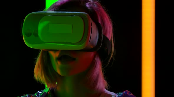 Portrait of a Young Stylish Woman with Virtual Reality Goggles. Close Up. Slow Motion.