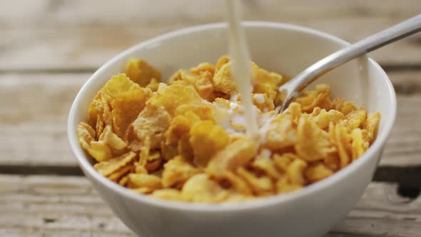 Video of cereals in ceramic bowl on wooden kitchen worktop