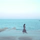 Woman Walks Along the Coastline on the Rocks - VideoHive Item for Sale