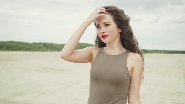 Pretty Woman Touching Hair on Beach