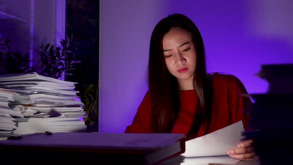 Stressed female freelancer worried about deadline job overtime at evening read information