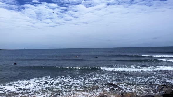 Slo-Mo of waves rolling in and surfers at Moffat Beach, Sunshine Coast Queensland Aus