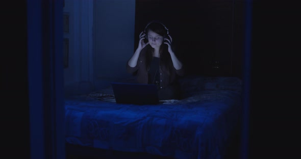 Young woman putting the headphones off