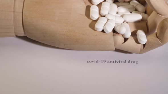 Closeup Shot of Pills on a Wooden Mannequin Hand