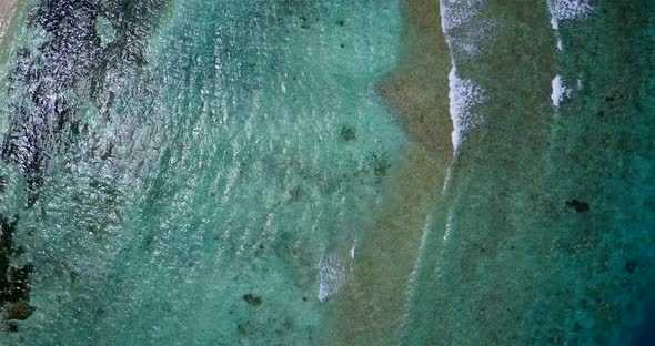 Wide drone abstract shot of a white paradise beach and aqua blue water background in colorful