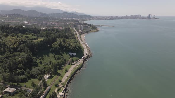 Aerial view of Georgian railway high speed train moving near the sea in Batumi. Georgia 2021