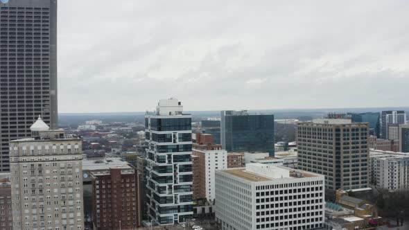 Drone shot above Midtown Atlanta on a cloudy day after a storm. Rising shot looking west over the Li