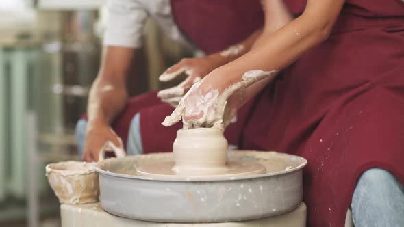 Joint Work Production of Handmade Tableware the Young Couple Potter Makes a Pitcher Out of Clay Top