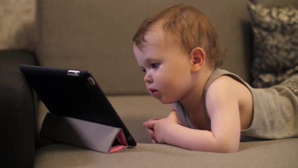 Child Looking on Tablet Laptop